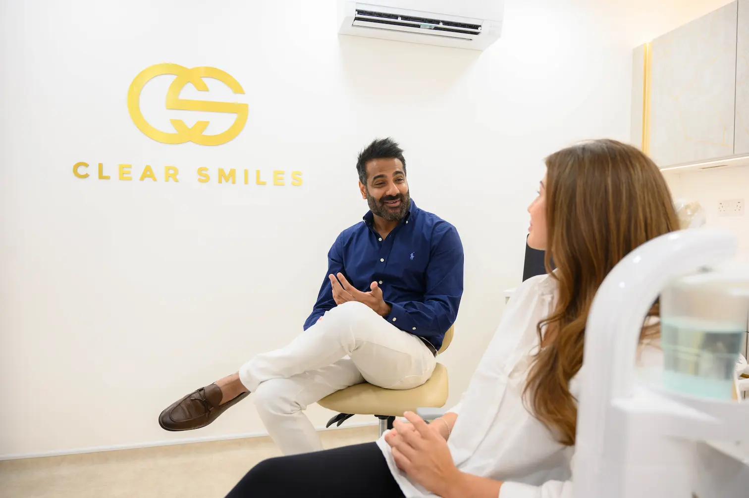 A patient listening to Dr. Chetan Sharma during an Invisalign consultation